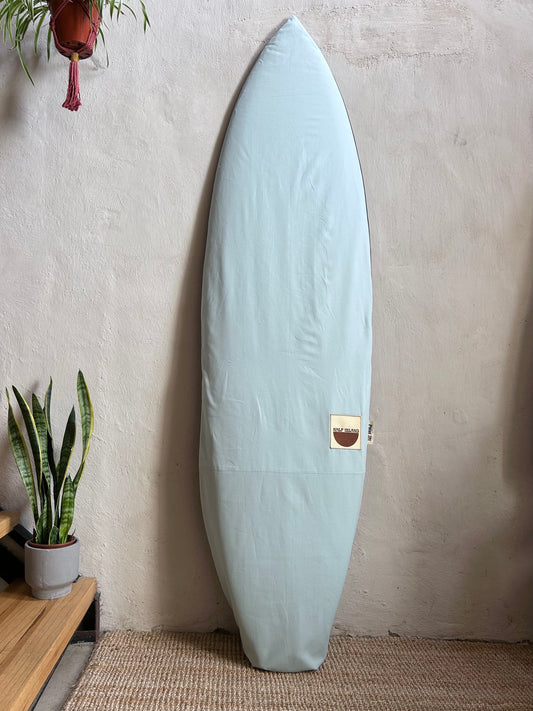 Light blue canvas surfboard bag.